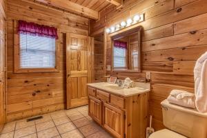 a log cabin bathroom with a sink and a toilet at Point Of View - Spacious 2 Bedroom With a Loft Just off Glades Road cabin in Gatlinburg +18 photos