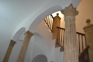 a stairway with columns and a staircase in a building at Il Palazzotto in Castel di Sangro
