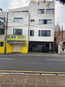 un edificio al lado de una calle de la ciudad en Apartamento Inteiro Central 2 Quartos e Kitnet Inteira 01 quarto, en Ponta Grossa