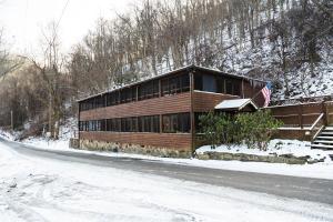a house on the side of a road in the snow at River Front Resort in Elkins