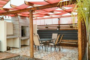 a patio with a table and chairs and a fireplace at Quintas Marlet en la ruta del vino in Ensenada