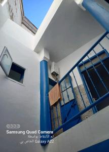 a towel is hanging on a blue pole on a house at DAR TAZROUT in Tangier +92 photos