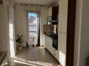 a kitchen with a window and a sink and a stove at La casa di Armando in San Gemini