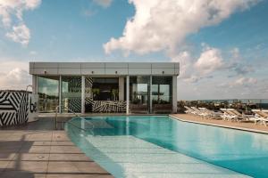 a swimming pool on the roof of a building at be.HOTEL in St. Julianʼs