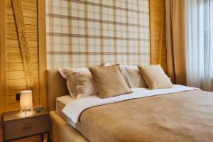 a bedroom with a large bed with a window at WILD BEAUTY Apartment-Modern mountain 2 in Kolašin