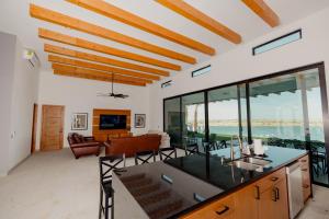 a kitchen and living room with a view of the ocean at Adora House in Puerto Peñasco