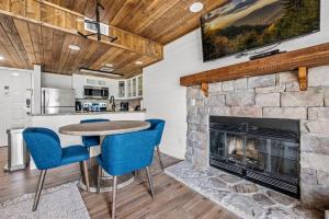 a living room with a fireplace and a table and chairs at Sky View Mountain Dream in Gatlinburg