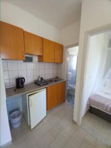 A kitchen or kitchenette at Kardamena Holiday Apartments