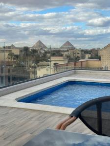 a swimming pool on the roof of a building at Sofia Pyramids Hotel in Cairo