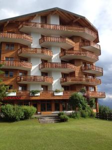 a building with balconies on the side of it at Apartment 162 - Bristol in Villars-sur-Ollon