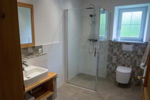a bathroom with a shower and a toilet and a sink at Bio-Bauernhof Eisele in Scheuring