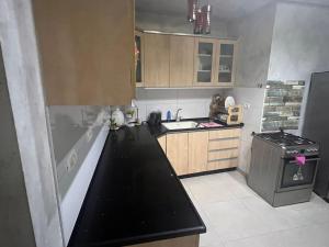 a small kitchen with a black counter top and a stove at Very nice apartment with view of all the old city in Jerusalem