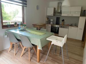 a kitchen with a green table and chairs in a room at Ferienwohnung-/Haus mit kostenfreiem Parkplatz in Kurort Altenberg +14 photos