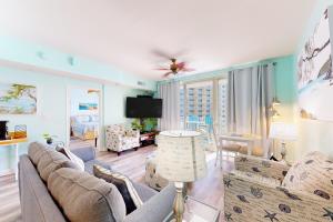 a living room with a couch and a tv at Shores of Panama, Unit #1415 in Panama City Beach