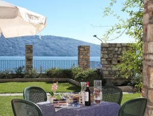 a table with wine glasses and wine bottles on it at Residence Borgo Dei Limoni - Appartamenti con Garage in Gargnano