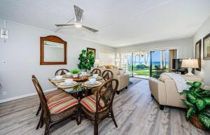 a living room with a table and chairs and a couch at Beachfront Aldea 5 in Clearwater Beach