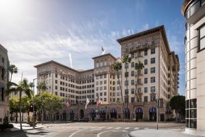 a large building with palm trees in front of it at Beverly Wilshire, A Four Seasons Hotel in Los Angeles