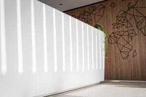 a white wall in a room with a plant at Best Western Plus Sabaudia Hotel in Sabaudia