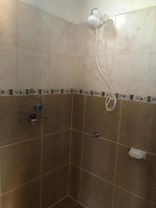 a shower with a shower head in a bathroom at Casa Ama in Puerto Iguazú