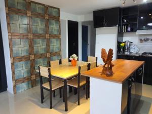 a dining room with a wooden table and chairs at Family Homestay with 3 Bedrooms in Suva
