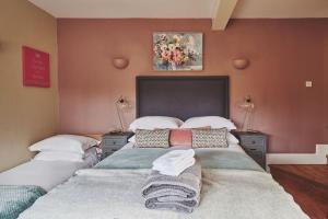 a bedroom with two beds with pillows on them at The Luxury Barn in Ashbourne