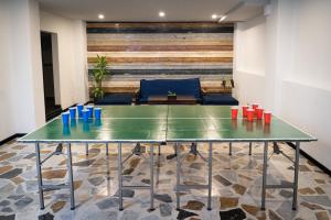 a ping pong table in the middle of a room at Next Door in Bogotá