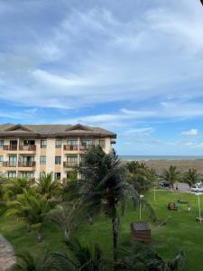 a resort with palm trees and a building at Apartamento Cumbuco, c2 307 in Caucaia