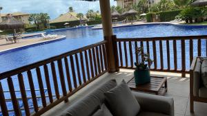 a view of a pool from the balcony of a resort at Apartamento Cumbuco, c2 307 in Caucaia