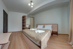 a bedroom with a bed with two towels on it at Dolyna Gir in Bukovel +25 photos