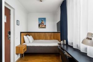 a small bedroom with a bed and a desk at Best Western Sjofartshotellet in Oskarshamn +73 photos