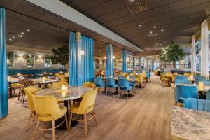 a restaurant with tables and chairs in a cafeteria at Best Western Karlshamn Spa & Relax in Karlshamn