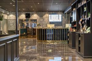 a bar in a restaurant with a tile floor at Best Western Karlshamn Spa & Relax in Karlshamn