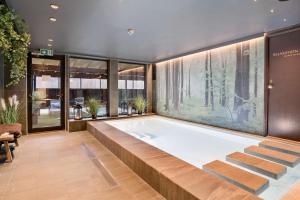 a jacuzzi tub in a room with windows at Best Western Karlshamn Spa & Relax in Karlshamn