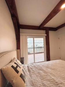 1 dormitorio con cama y ventana en NEW Bijou Bayside Escape- 3beds, Balcony, Deck, Dock en Ocean City