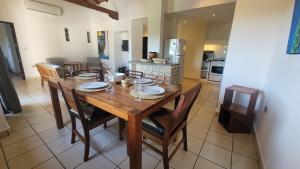 a dining room with a wooden table and chairs at Condo Golf B3 F3 Hacienda Iguana in Tola