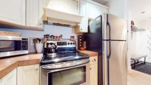a kitchen with a stove and a refrigerator at Summit #92 condo in Mammoth Lakes +32 photos