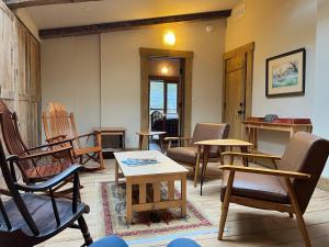 a living room with chairs and tables and a table at The Squibb Houses in Cambria