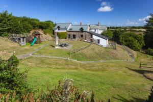 a house on a hill with a playground at Puffin Cottage at Robin Hill 6 in Bideford