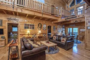 a living room with leather furniture in a log cabin at ERN854 - Wagon Wheel Lodge - Great Location! Close To All The Action! cabin in Pigeon Forge