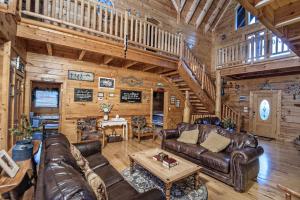 a living room with leather furniture in a log cabin at ERN854 - Wagon Wheel Lodge - Great Location! Close To All The Action! cabin in Pigeon Forge +69 photos