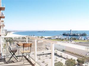 a balcony with a table and chairs and the beach at Ocean Views Penthouse 2b 2b Majestic Apartment 5 min to Convention Center in Long Beach