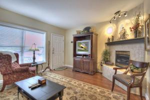 a living room with a tv and a fireplace at Colonial Crest 107 - Great location! - You can walk to town! condo in Pigeon Forge