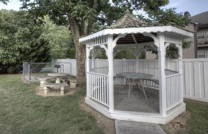 a white gazebo with a table and a bench at Colonial Crest 112 - Great location! - You can walk to town! condo in Pigeon Forge