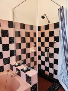 a bathroom with a black and white tiled wall at Seaside Cottage with Jetty in Point Clare