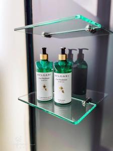 a glass shelf with three bottles of soap at Wonderwall in Wujie