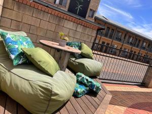 a patio with a table and pillows on a deck at Mulwala Paradise Palms Motel in Mulwala