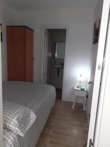 a bedroom with a bed and a bathroom with a sink at Apartamento C in Madrid