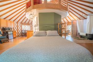 a bedroom with a large bed in a room at Strawhouse Resorts in Big Bar