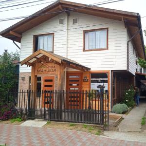 un edificio con un cartel en la parte delantera en Hostal Mahuida en Pucón