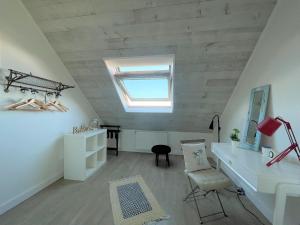 a attic room with a desk and a skylight at Charming holiday home near the beach, Locquirec in Locquirec